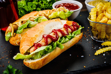 Hot dogs and french fries on cutting board