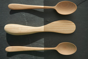 Close-up of a wooden spoon and a kitchen utensil