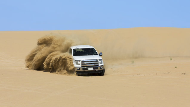 Special Utility Vehicle driving off-road on sand dune