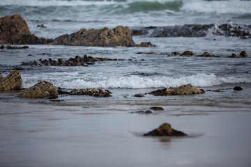 Fototapeta na wymiar Close up of waves on the shore at West Point State reserve, Tasmania, Australia.