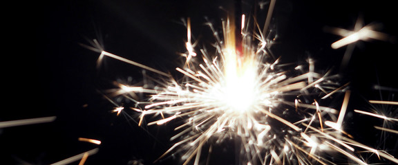 banner wor website, A burning sparkler on a black background