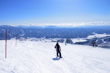 Fototapeta na wymiar Panoramic snow boarding at hakuba happo in Nagano Japan with blue