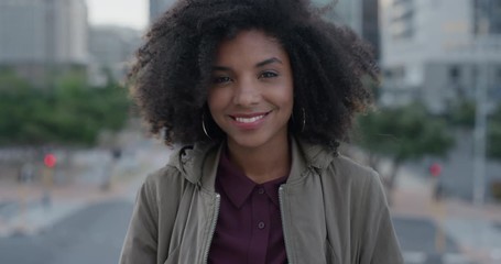 portrait beautiful young african american woman smiling enjoying successful urban lifestyle independent black female student in city slow motion - Powered by Adobe