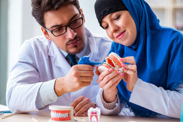 Dentist doctor and assistant working on new tooth implant