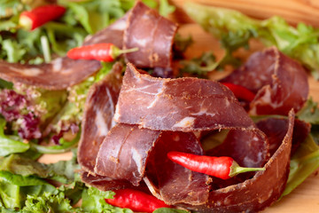 Dry beef jerky with herbs and red peppers.