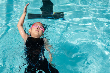 a girl learn how to swim in swimming class