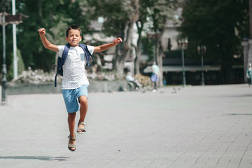 the boy runs to school