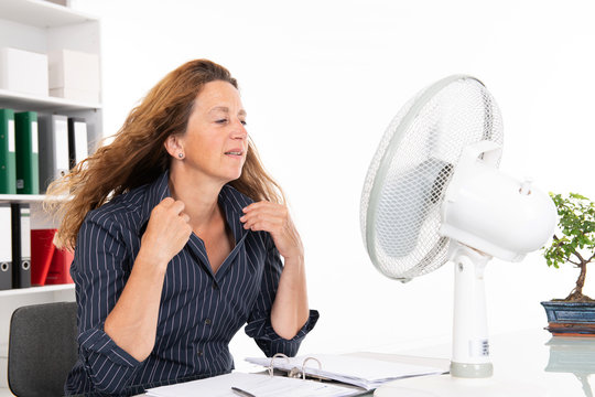 Young Business Woman With Ventilator At His Desk In Summerly Hot O