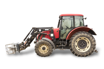 Tractor with hydraulic lift for carrying bales of hay and silage.Isolated foto of the side of the agricultural machine.The equipment for a dairy farm.