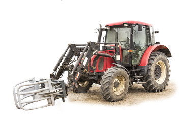 Tractor with hydraulic lift for carrying bales of hay and silage.Isolated photo of a general view of an agricultural machine.The equipment for a farm.