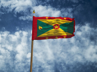 Grenada flag Silk waving flag of Grenada made transparent fabric with wooden flagpole gold spear on background sunny blue sky white smoke clouds real retro photo Countries of world 3d illustration