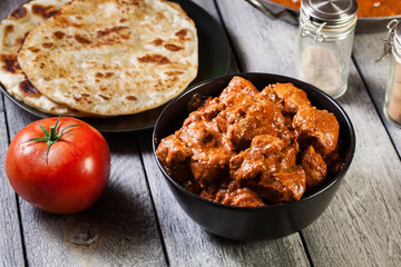 Chicken tikka masala served with bread naan
