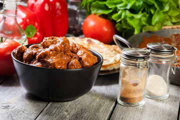Chicken tikka masala served with bread naan