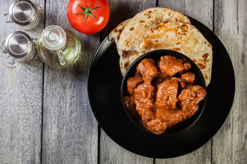 Chicken tikka masala served with bread naan