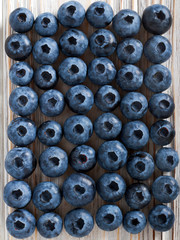 Blueberry over light wooden background