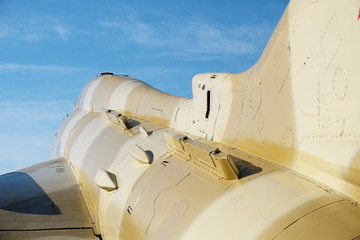 part of the military fighter aircraft su-17 view from the tail against the blue sky