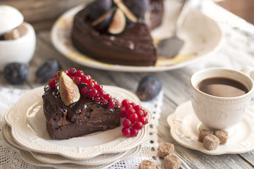 chocolate cake with berries and coffee, decor of red currants and figs. Autumn fruits and pastries for breakfast