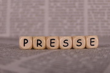 Presse, Würfel, Holzwürfel auf Zeitungspapier