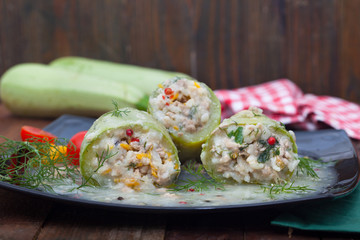 Stuffed zucchini with rice, minced meat and vegetables in sauce. Homemade healthy cuisine.