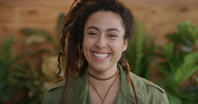 portrait of beautiful young mixed race woman smiling happy enjoying successful lifestyle wearing dreadlocks hairstyle independent female slow motion