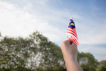 Independence Day concept. A happy and proud boy holding Malaysian flag.