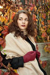 woman in a  coat walks in autumn park