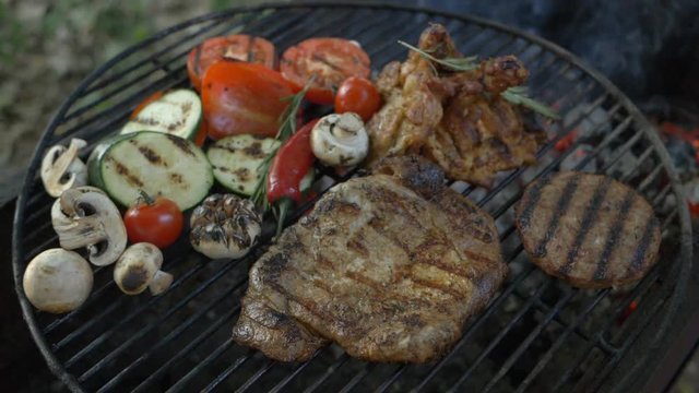 BBQ outdoors. Country rest, juicy and tasty bbc burger cutlet, beef steak, grilled chicken leg, fresh vegetables special on summer picnic