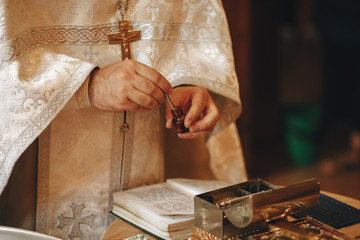 the Holy father is preparing for the baptism of the baby in the Church.
