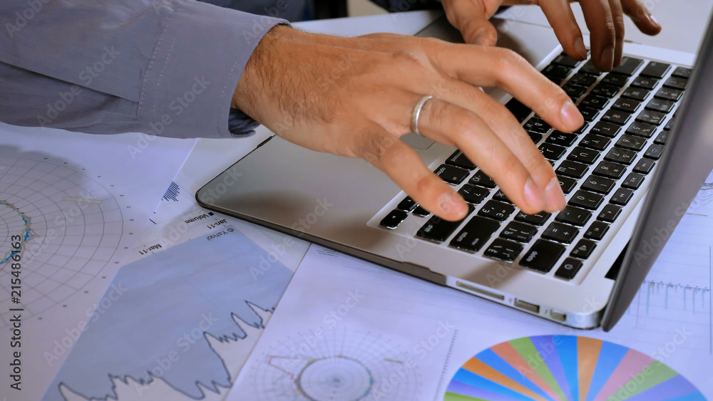 Poster unrecognizable business man entering data on computer