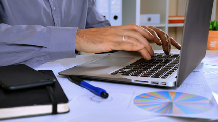 unrecognizable worker surfing internet on computer