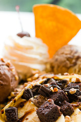 tasty pancakes with chocolate ice cream crispy waffle whipped cream with brownies cherry almond and chocolat syrup on top.served pancakes crepes on plate.sweets dessert brownies pancakes crepes.