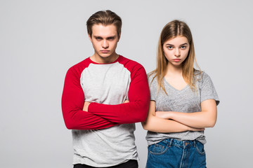 Portrait of happy couple standing with arms crossed on white background