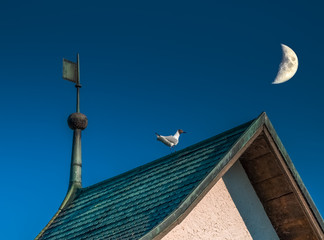 Crescent moon over the town of Hurden, Schwyz, Switzerland