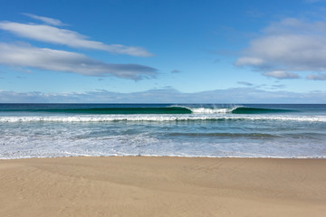 Wave breaking on the beach in Bruny Island, Tasmania, Australia