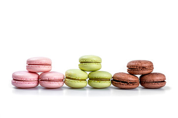 Obraz na płótnie Canvas Delicious multicolored french macaroons or macaron on a white background whith place for insert text. Copy space
