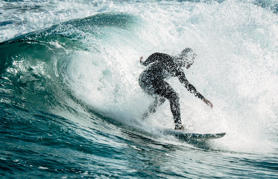 Silhouette of a surfer surfing a wave in the north of Spain