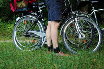 Fototapeta na wymiar Man stands next to bicycles