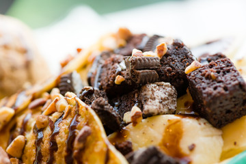 tasty pancakes with chocolate ice cream crispy waffle whipped cream with brownies cherry almond and chocolat syrup on top.served pancakes crepes on plate.sweets dessert brownies pancakes crepes.