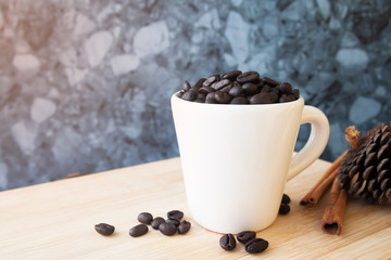 White cup with coffee beans on wooden table, Coffee and lifestyle