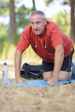 mature male athlete exercising in nature