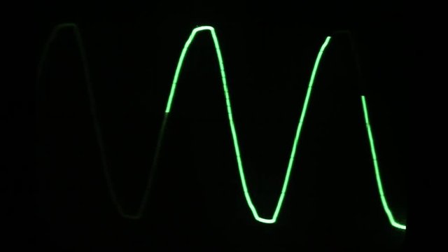 Audio signal on oscilloscope screen. Communication and electronics. Close up
