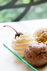 tasty pancakes with chocolate ice cream crispy waffle whipped cream with brownies cherry almond and chocolat syrup on top.served pancakes crepes on plate.sweets dessert brownies pancakes crepes.