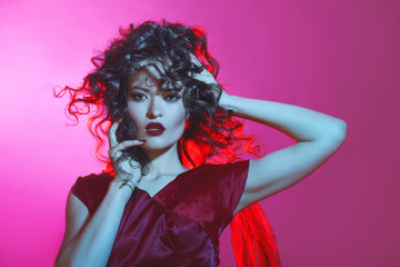 Portrait of an attractive brunette with lush styling and red lipstick