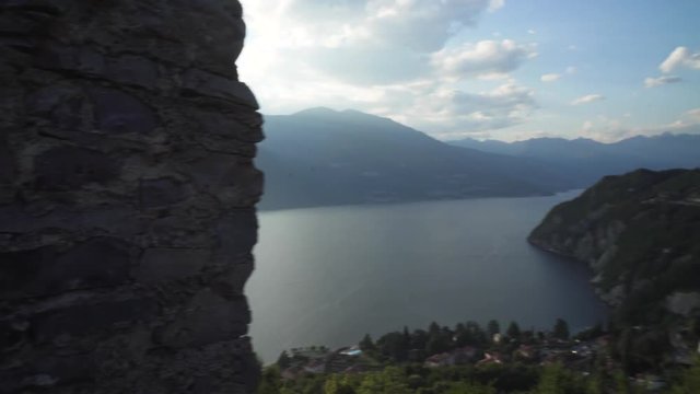 vezio castle, view over the lake and the alps mountains , inside of the old stone castle there are lot of sculpture of gosth