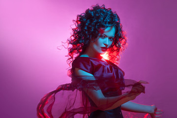 Gothic girl in red. Dancing woman with flying red dress.