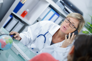 female doctor on phone at office