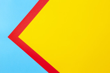 Color papers geometry flat composition background with yellow red and blue tones