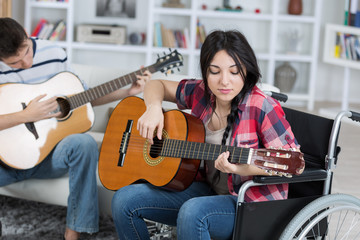 young disabled girl playing guitar