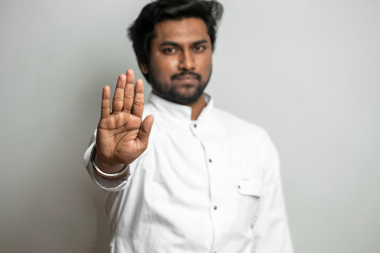 indian handsome man showing 'no' gesture. stop keep calm. watch out. mesmerizig process. hipnotize people. indian hypnosis. stop drinking alcohol, smoking