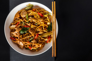 wok stir-fry egg noodles with fried chicken and thai spices and, traditional spicy asian cuisine food